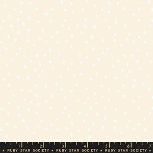 May include: Cream-colored fabric with a scattered pattern of white stars. The fabric has a soft, matte finish. The bottom of the image includes a ruler with the text "RUBY STAR SOCIETY".