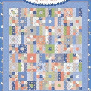 May include: A patchwork quilt with a blue floral border and a central design of squares and rectangles in shades of blue, peach, green, and gray. The quilt features the text "Coriander Quilts by Corey Yoder" and "#200 Jelly Roll Patchwork".