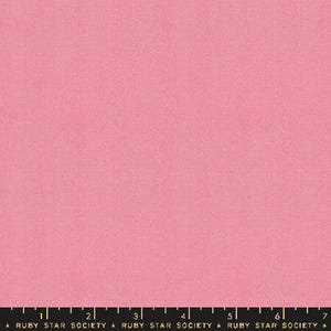 May include: A solid pink fabric with a subtle texture. The fabric is a light pink color and has a slightly grainy appearance.