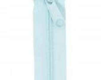 May include: A light blue zipper with a metal slider. The zipper is closed and the slider is in the middle of the zipper.