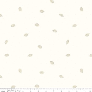 May include: A white fabric with a repeating pattern of beige leaves. The fabric is textured and has a subtle speckled appearance.