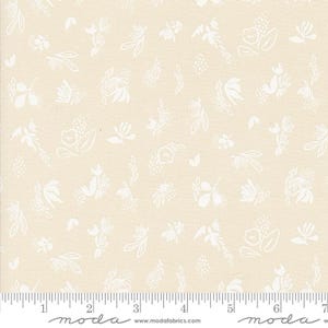 May include: A beige fabric with a white floral pattern. The pattern features small, simple flowers and leaves. The fabric is perfect for quilting, sewing, and crafting.