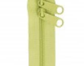 May include: A light green zipper with two pull tabs. The zipper is closed and has a metal slider.