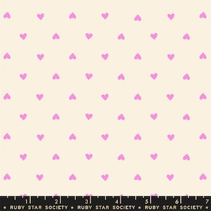 May include: Cream-colored fabric with a repeating pattern of small, light purple hearts. The hearts are evenly spaced across the surface. The text "RUBY STAR SOCIETY" is printed at the bottom.