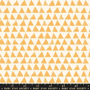 May include: A white fabric with a repeating pattern of orange triangles. The triangles are slightly distressed and have a hand-drawn look. The fabric is marked with a ruler and the text "RUBY STAR SOCIETY".