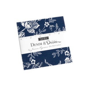 May include: A blue fabric square with a white floral pattern. The fabric is labeled "Denim & Daisies by Joanna Figueroa Fig Tree & Co."