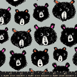 May include: A repeating pattern of black bear faces on a light gray background. The bears have white eyes and noses and pink accents.