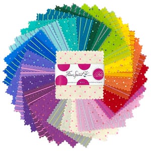 May include: A circular arrangement of colorful fabric squares in a variety of patterns and colors, including polka dots and stripes. The fabric squares are arranged in a rainbow gradient. A label with the text "Free Spirit" is in the center.