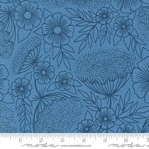 May include: Blue fabric with a white floral pattern. The pattern includes flowers, leaves, and small dots. The fabric is textured and has a subtle sheen.