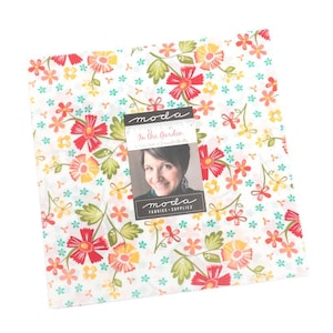 May include: A square fabric bundle with a floral pattern featuring red, yellow, and orange flowers with green leaves on a white background. The fabric is labeled "In the Garden" by Moda Fabrics + Supplies.