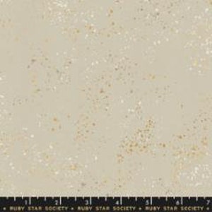 May include: A beige fabric with a scattered gold glitter pattern. The fabric has a subtle sheen and a soft texture.