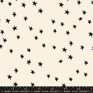 May include: Cream-colored fabric with a scattered pattern of black, hand-drawn stars. The stars vary in size and are evenly distributed across the surface. The bottom of the fabric has a black border with text that reads "RUBY STAR SOCIETY".