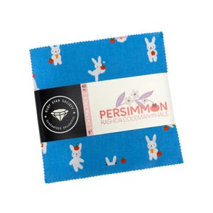 May include: A stack of 42 fabric squares in a 5-inch charm pack, featuring a bright blue background with a repeating pattern of white rabbits holding red persimmons. The paper band displays the text Ruby Star Society, Persimmon, and Rashida Coleman Hale.