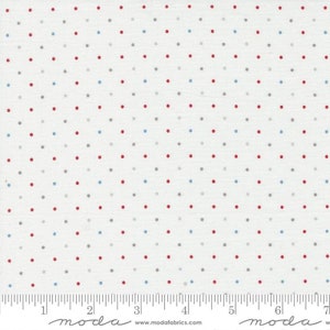 May include: White fabric with a repeating pattern of small red, gray, and blue dots. The fabric is marked with a ruler that reads "moda" and "www.modafabrics.com".