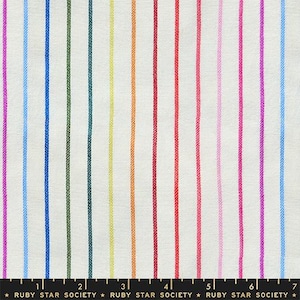 May include: White fabric with vertical stripes in various colors, including pink, blue, green, yellow, orange, and red. The fabric has a textured appearance. The text at the bottom reads "RUBY STAR SOCIETY".