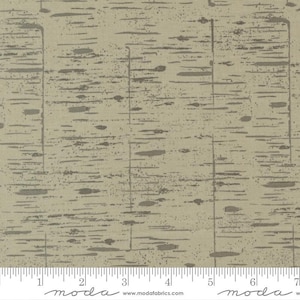 May include: A beige fabric with a subtle, textured pattern of gray lines and dots. The fabric has a slightly rough, linen-like feel.