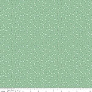 May include: A green fabric with a white floral pattern. The fabric is covered in small white flowers with green leaves.