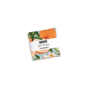 May include: A fabric square with a blue background and a pattern of oranges, leaves, and flowers. The fabric is labeled "Fruit Loop" by BasicGrey.