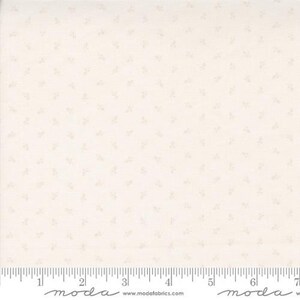 May include: White fabric with a subtle, light pink floral pattern. The fabric is a cotton blend and is perfect for quilting, sewing, and crafting.