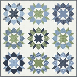 May include: A patchwork quilt featuring nine starburst designs. Each starburst is composed of blue and green fabric pieces, with floral and geometric patterns. The quilt has a cream-colored background and a square shape.