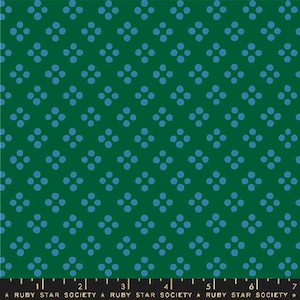 May include: Green fabric with a repeating pattern of blue four-dot clusters. The fabric has a ruler along the bottom edge with the text "RUBY STAR SOCIETY". The pattern is a simple, yet elegant design.