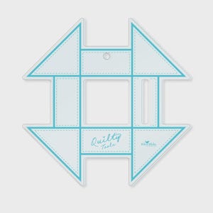 May include: A white quilting template with a light blue outline and stitching detail. The template has a geometric design with the words "Quilty Tools" and "Riley Blake" printed on it. It is designed for quilting.