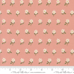 May include: A pink fabric with a white floral pattern. The fabric has a repeating pattern of small white flowers with green stems. The fabric is a light pink color and has a subtle texture.