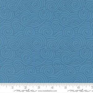 May include: Blue fabric with a repeating pattern of swirling lines. The design features a textured appearance, with the lines in a slightly darker shade of blue. A ruler is at the bottom of the image, with the word "moda" printed on it.