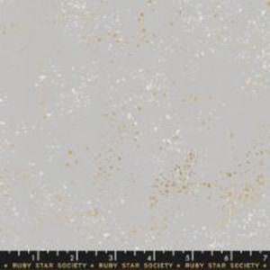 May include: A gray fabric with a scattered pattern of white and gold flecks. The fabric has a subtle texture.