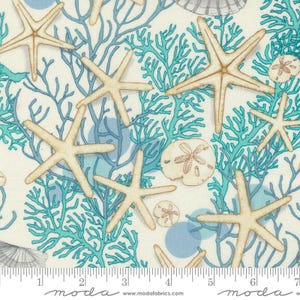 May include: A white fabric with a repeating pattern of blue coral, starfish, and seashells. The fabric has a white background with blue coral, starfish, and seashells.
