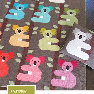 May include: A quilt and pillow pattern featuring colorful koala designs. The koalas are in various colors, including blue, yellow, pink, and red, set against a brown background. The text "KOALAS" is displayed at the top.
