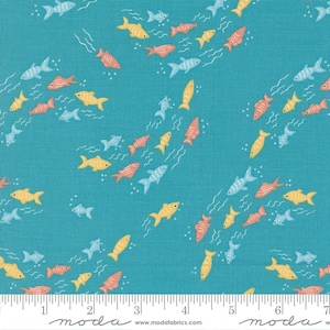 May include: A turquoise blue fabric with a repeating pattern of colorful fish swimming in a school formation. The fish are in shades of orange, yellow, and blue. The fabric has a subtle texture and a white ruler with black markings at the bottom.
