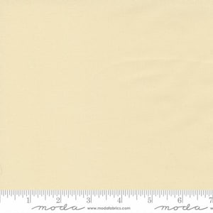 May include: A solid cream colored fabric swatch with a ruler showing 7 inches.
