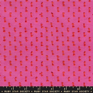 May include: Bright pink fabric with a textured surface and scattered orange bow-shaped embellishments. The fabric has a woven appearance and is suitable for various sewing projects. The Ruby Star Society logo is at the bottom.