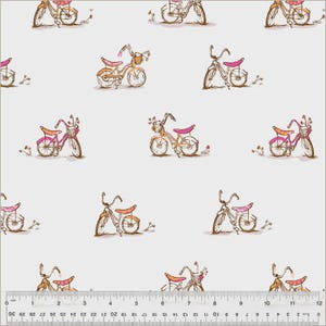 May include: A repeating pattern of sketched bicycles in shades of brown, pink, and orange on a white background. The bicycles have baskets and flower accents. A ruler is at the bottom of the image.