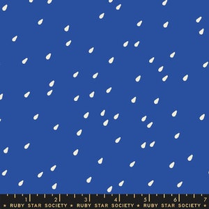 May include: A blue fabric with a white raindrop pattern. The fabric is a solid blue color with white raindrops scattered across the surface. The raindrops are a simple, hand-drawn design.