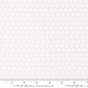 May include: Off-white fabric with a repeating pattern of white four-leaf clover shapes. A ruler is at the bottom of the image, with measurements in inches. The fabric has a subtle texture and is suitable for quilting or crafting projects.