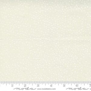 May include: White fabric with a subtle, evenly spaced pattern of small white dots. The fabric is textured and has a slight sheen. The fabric is measured in inches with the text "moda" printed on the ruler.