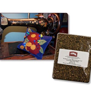 May include: An antique black sewing machine with floral accents and a blue star-shaped pincushion adorned with red and yellow felt flowers. A package of crushed black walnut shells is also shown.