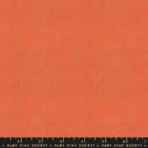 May include: A solid coral orange fabric with a subtle woven texture. The fabric is a plain weave with a smooth, slightly textured surface.