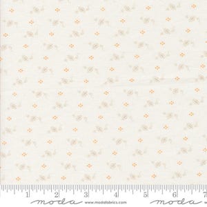 May include: Cream-colored fabric with a repeating pattern of small, stylized floral designs and orange dots. The fabric has a subtle texture and is suitable for quilting or other craft projects. The image includes a ruler along the bottom edge.