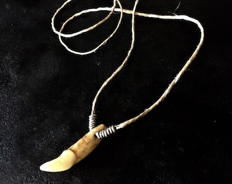 Wolf tooth necklace on a hemp cord, wolf tooth necklace, light colored wolf tooth on a hemp necklace, wolf tooth necklace with silver rings
