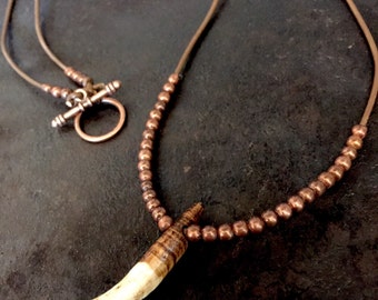Wolf tooth necklace on a dark brown leather cord with copper colored beads, wolf tooth necklace, wolf tooth jewelry, wolf fang necklace, wol
