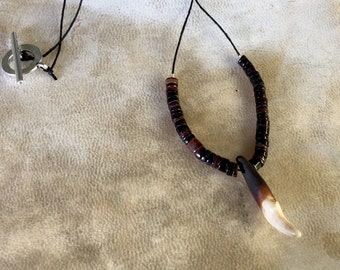 Wolf tooth and dark brown penn shell necklace on a thin black hemp cord, wolf tooth necklace, wolf tooth necklace and dark brown penn shell
