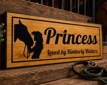 May include: Wooden sign with the word "Princess" and a silhouette of a horse and rider. The sign is on a wooden surface with a horse in the background. A leather and rope horse lead is in the foreground. The sign reads "Loved by Kimberly Walters."
