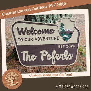 May include: A brown and tan wooden sign with the text "Welcome to our adventure" and "The Poferls" with a green and white park ranger logo and the text "EST 2024".