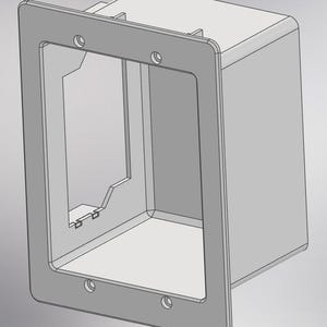 May include: A light gray electrical box with a rectangular faceplate. The faceplate has rounded corners and four screw holes. The box has an open interior and is designed to house electrical components. The overall design is simple and functional.