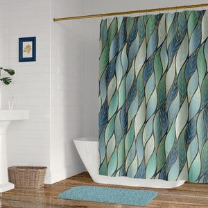 May include: A shower curtain featuring a repeating pattern of elongated, overlapping leaves in shades of teal, navy blue, and light green, accented with thin, gold-colored outlines that create a flowing, vertical design across the fabric surface.