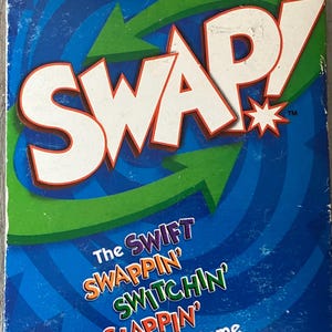 May include: A blue and green game box with the word "SWAP!" in large white letters. The text "The SWIFT SWAPPIN' SWITCHIN' SLAPPIN' Card Game" is printed below the title.