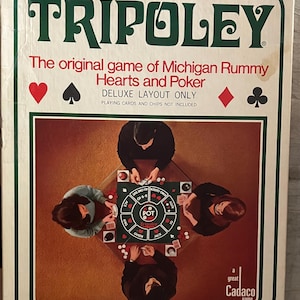 May include: A vintage Tripoley board game box. The box features the game's name in large green letters, with the text "The original game of Michigan Rummy Hearts and Poker." The box shows a deluxe layout with four people playing the game.